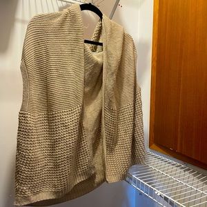 Cape style vest/sweater with hoodie.